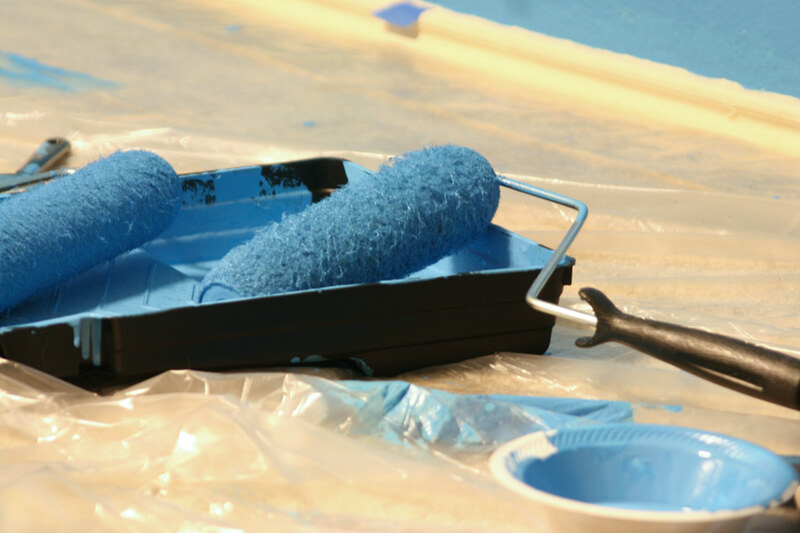 Paint Roller in Tray with Blue Paint