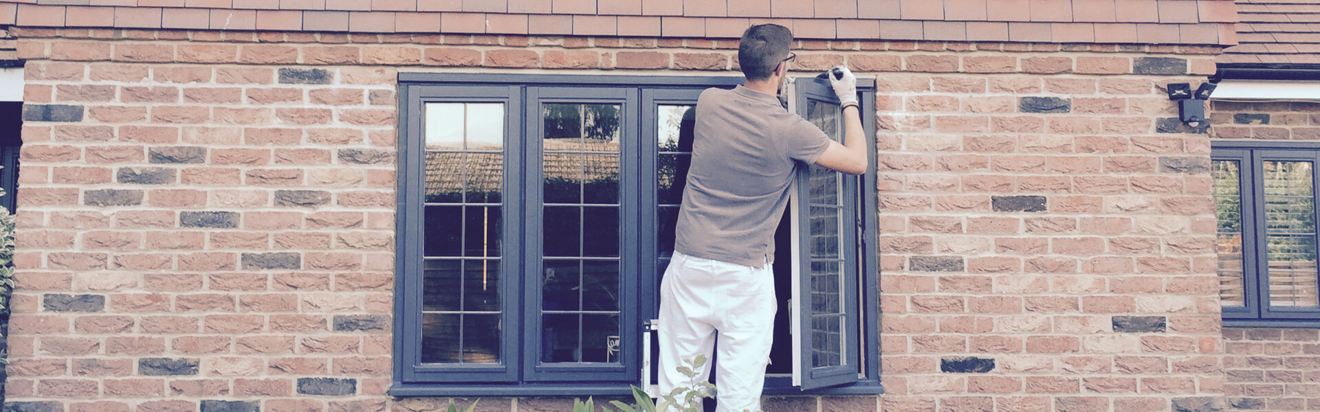 Man Painting Exterior Window Frames