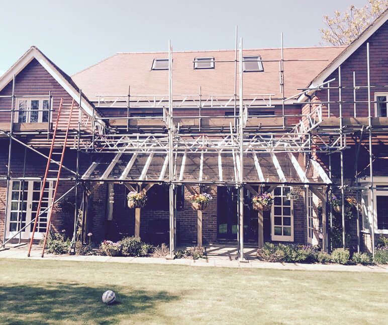 Exterior of property with scaffolding and ladders